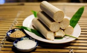 A plate of bamboo rice sticks accompanied by a small bowl of salt, showcasing traditional Vietnamese cuisine.