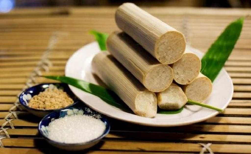A plate of bamboo rice sticks accompanied by a small bowl of salt, showcasing traditional Vietnamese cuisine.